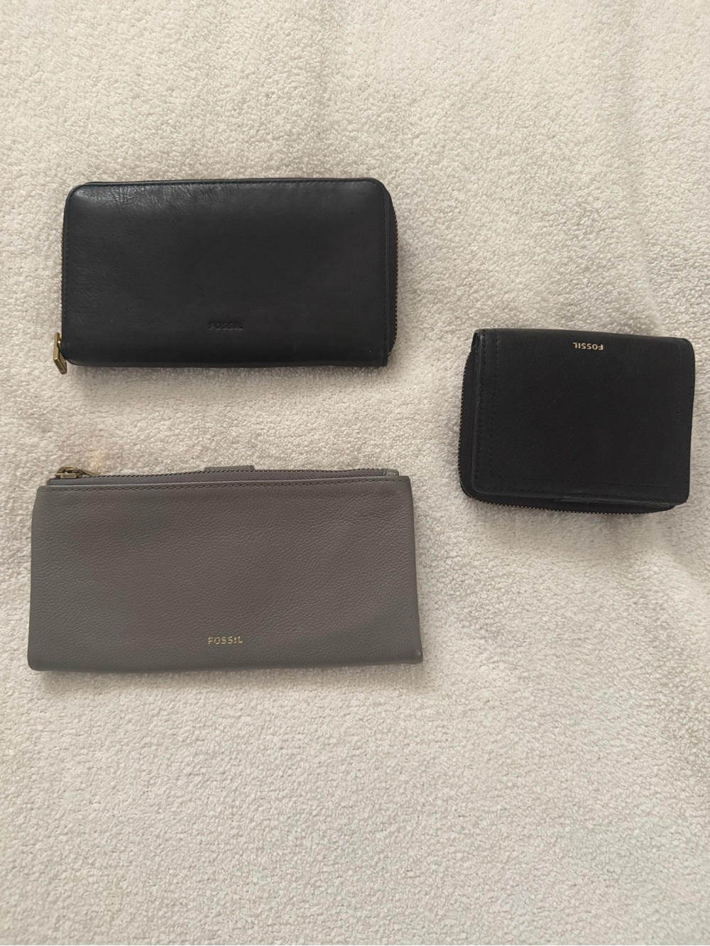 Set of three Fossil wallets. Two black, one grey.